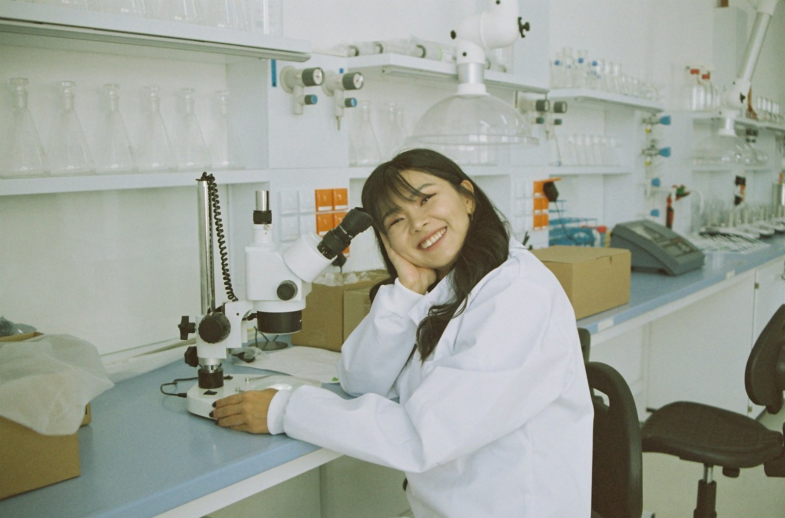 Technician inspecting lyophilised vials after freeze-drying