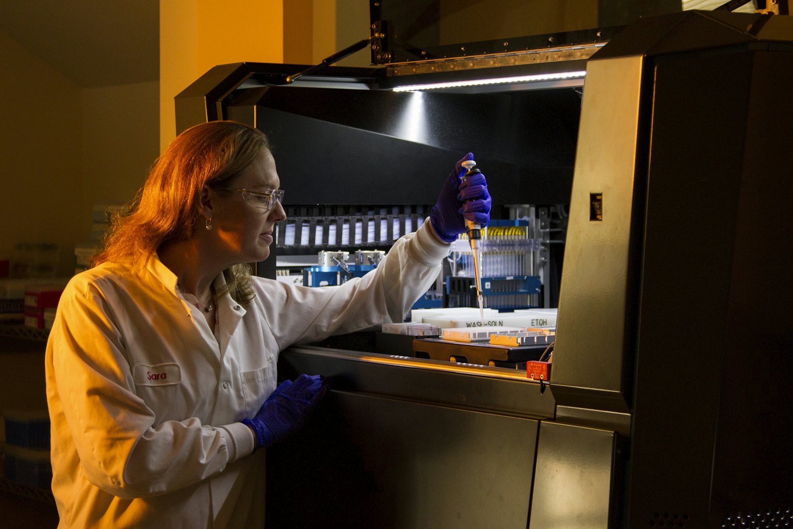 Researcher checking a certificate of analysis against a vial label
